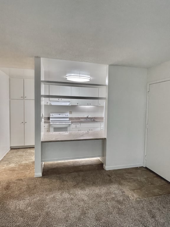 an empty room with a bookshelf in the corner