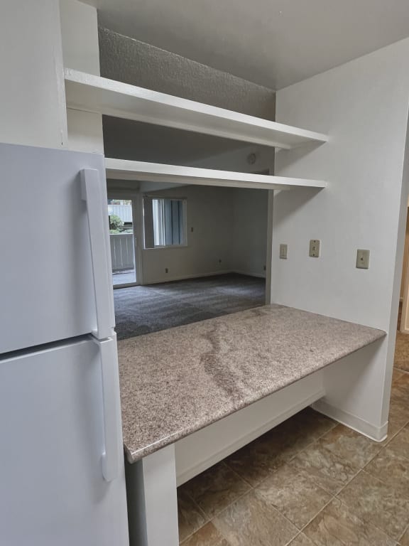 a kitchen with an island and a refrigerator