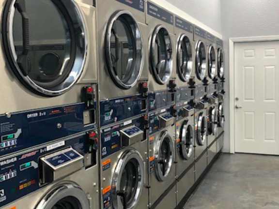 A row of washing machines in a laundromat.