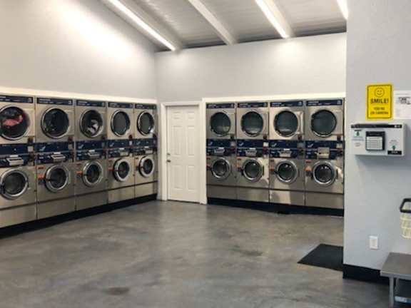 A laundromat with rows of washing machines.