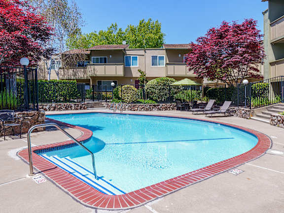 A swimming pool surrounded by a red brick border.
