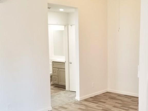 A white bathroom with a sink and mirror.
