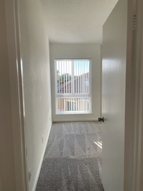 Tassajara 2x2.25  small bedroom entry featuring new carpeting