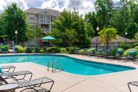 swimming pool with cushioned seats at rose heights apartments in raleigh, NC
