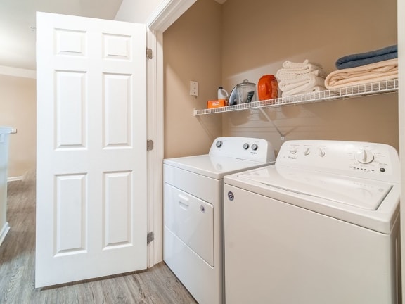 a white washer and dryer in a laundry room with a closet at Legends at Rancho Belago, California