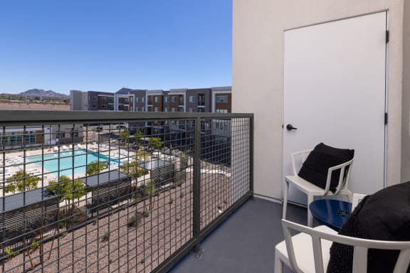 apartment balcony with a pool and buildings in the background at  Element 12