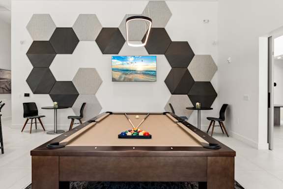 a games room with a pool table and a geometric wall at Mira at Palmer Ranch in Sarasota, FL