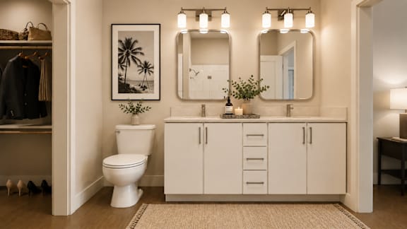 A white bathroom with a toilet, sink, and mirror.