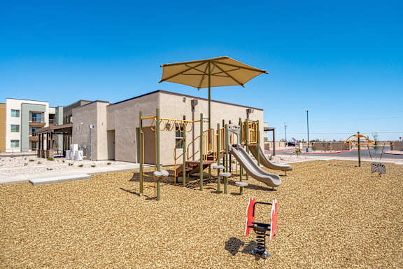 A playground with a slide, swings, and a climbing frame.