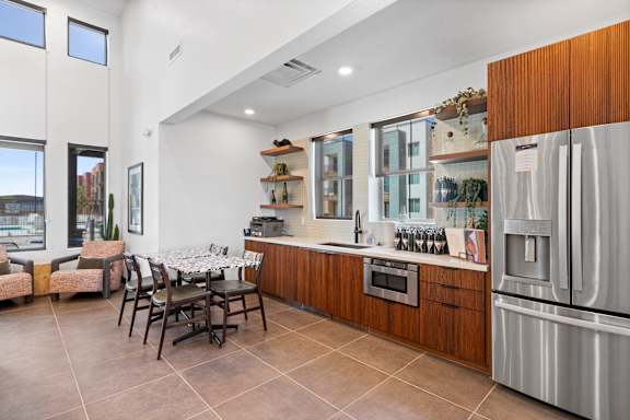 A modern kitchen with a dining table and chairs.