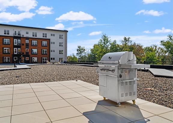 a barbecue grills on the patio at the reserve at johns creek walk