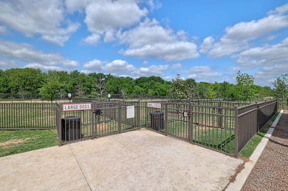 A fenced area with a sign that says Large Dogs.