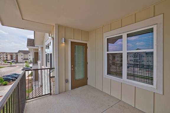 A balcony with a view of a residential area.