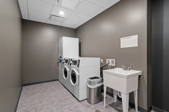 a washing machine and a sink in a laundry room