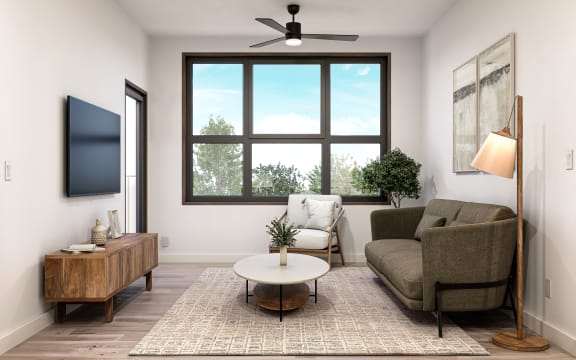 a living room with a window and a couch and a coffee table