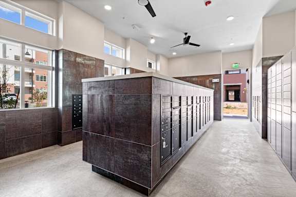 A long hallway with a brown cabinet in the middle.