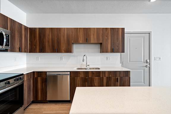 A modern kitchen with wooden cabinets and stainless steel appliances.