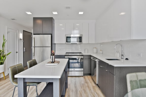a kitchen with white countertops and stainless steel appliances  at 1405 Point, Maryland
