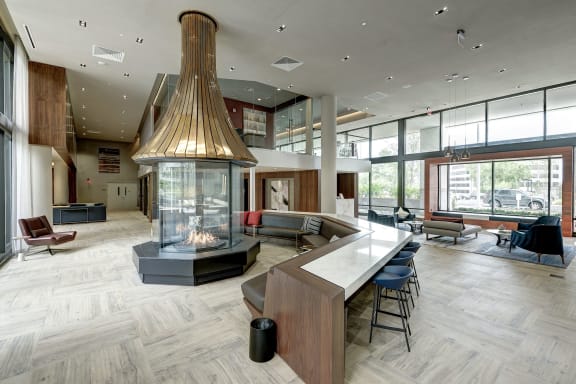 a large clubhouse with a fireplace and a large table and chairs at Highgate at the Mile, McLean, VA 22102