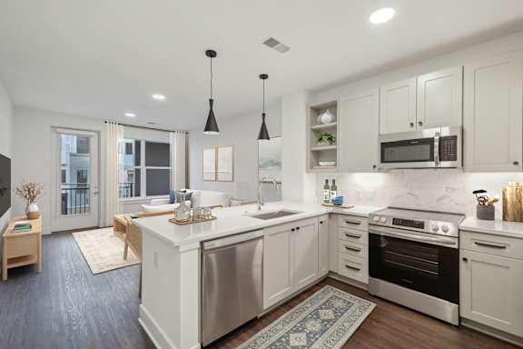 A modern kitchen with a large island and stainless steel appliances. at The Sully, Chantilly, 20151