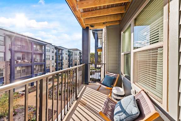 A balcony with a bench and pillow on it.