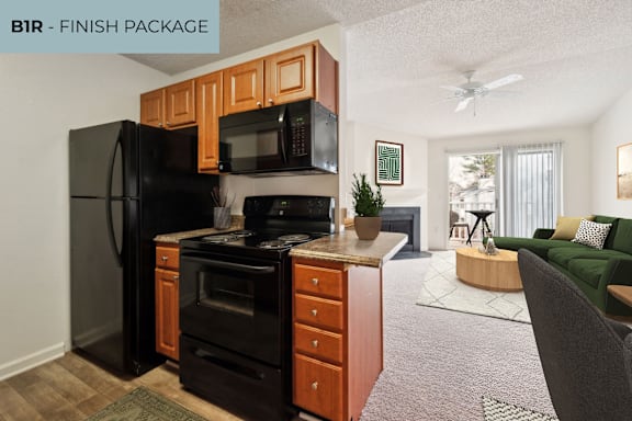 A kitchen with a black refrigerator and a black stove top oven.