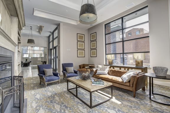 a living room with couches and chairs and a fireplace at The Gunther, Baltimore, MD, 21224
