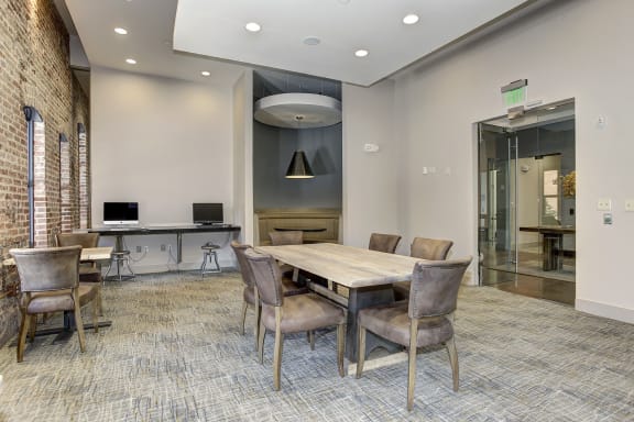 a conference room with a large table and chairs and a glass door at The Gunther, Baltimore, Maryland