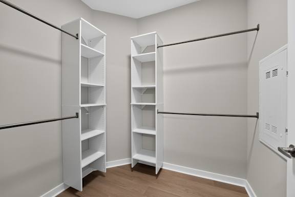 Closet with shelves and a door.