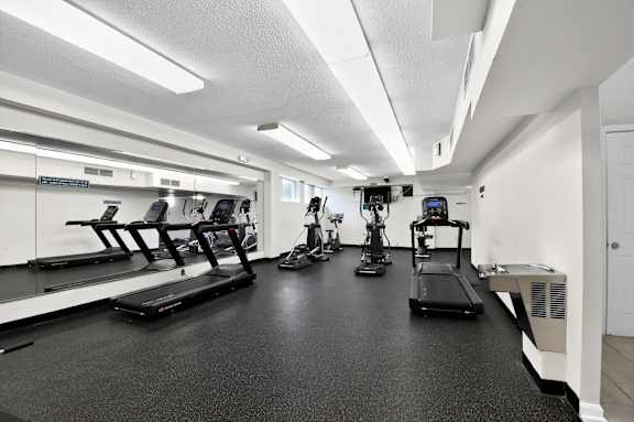 A gym with treadmills, elliptical machines, and other exercise equipment at Avondale Overlook, Maryland