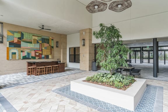 a lobby with a garden and a painting on the wall  at La Unión, Tampa, 33605