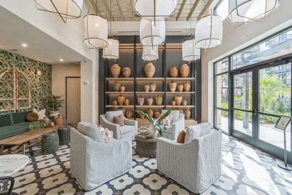 a lobby with chairs and a wall filled with vases at La Unión, Tampa, 33605