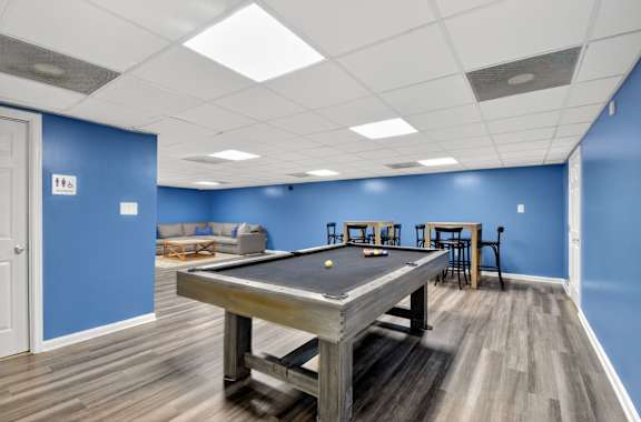 A pool table in a room with blue walls at Avondale Overlook, Maryland
