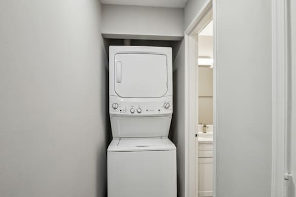 A white washing machine in a small room.