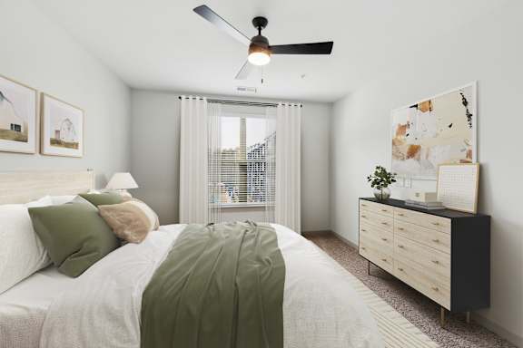 A bedroom with a bed, dresser, and ceiling fan.