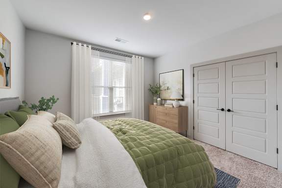 A bedroom with a bed, nightstand, and wardrobe.