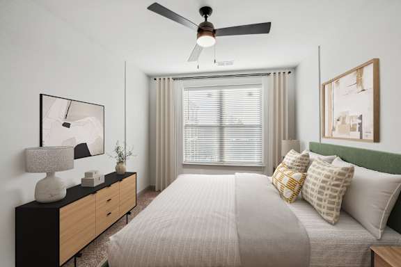 A bedroom with a bed, nightstand, and a ceiling fan.