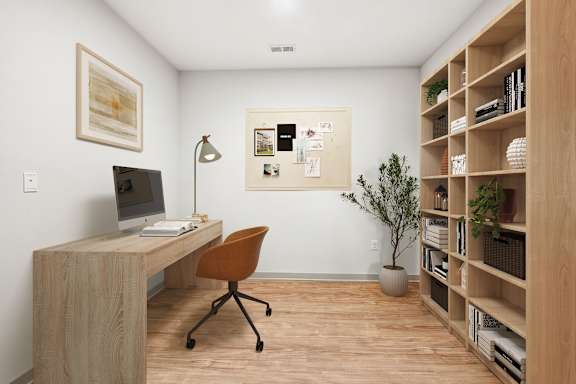 A room with a desk, chair, and bookshelf.