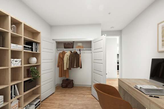 A room with a wooden shelf, a chair, a desk, and a closet.
