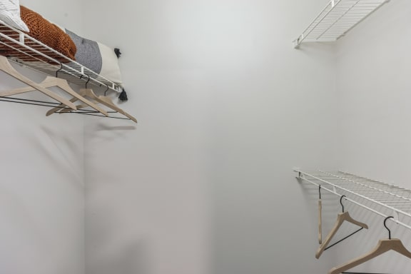 a room with white walls and a closet with shelves and hangers on the wall at St. Andrews Reserve, North Carolina, 28412