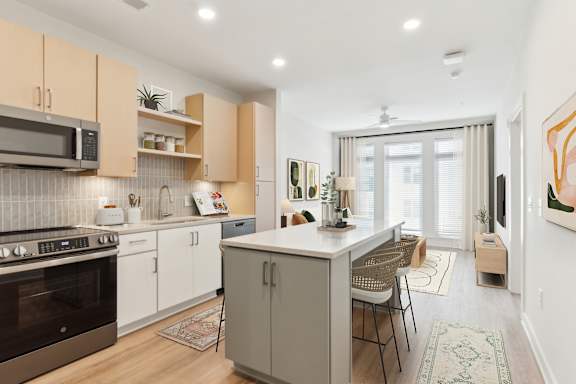 A modern kitchen with a large island and stainless steel appliances at Hawkins Press, Charlotte, North Carolina