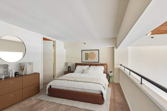 A bedroom with a large bed and a brown dresser at Tindeco Warf, Baltimore Maryland