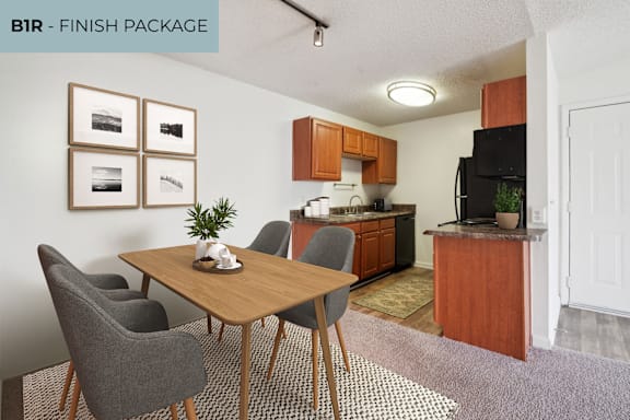 A kitchen with a dining table and chairs.