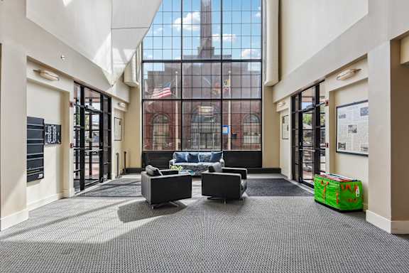 A large room with a glass wall and a couch in the lobby at Tindeco, Wharf, Baltimore, MD 21224