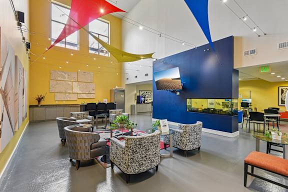 A sitting area with chairs and a TV at clubhouse at at Tindeco, Wharf, Baltimore, MD 21224