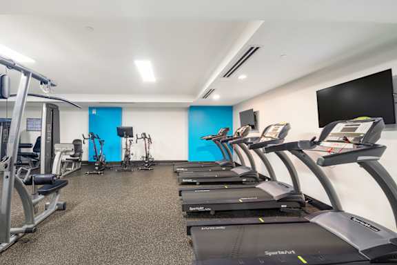 A gym with treadmills and exercise equipment. at Loree Grand at Union Place, Washington, DC, 20002