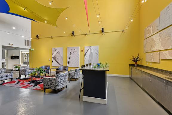 A room with a yellow wall and a black and white rug in clubhouse at at Tindeco, Wharf, Baltimore, MD 21224