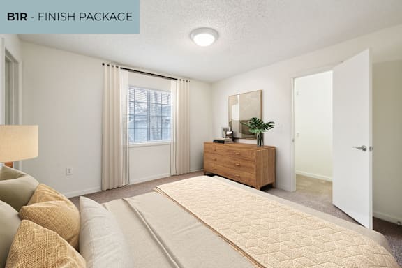 A bedroom with a large bed and a wooden dresser.