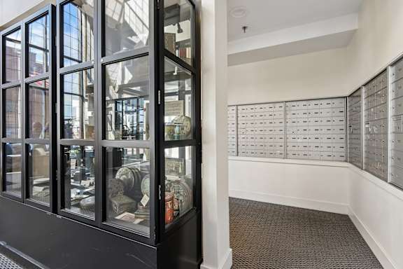 A room with a row of mailboxes on the wall at Tindeco Wharf, Maryland, 21224