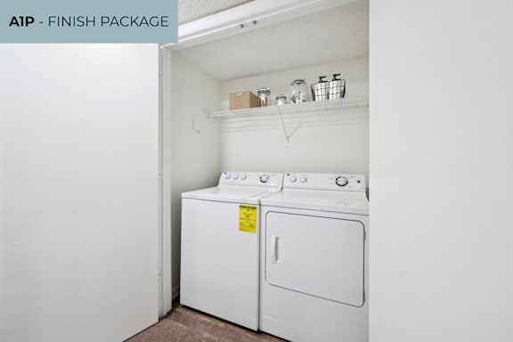 A white washing machine and dryer in a small laundry room.